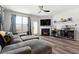 Relaxing living area with fireplace, large windows and hardwood floors at 2528 Shropshire Pl, Mcdonough, GA 30253