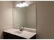 Bathroom with a vanity and large mirror at 7594 Shady Maple Way, Lithonia, GA 30038