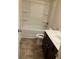 Bathroom with tub, toilet, and dark brown vanity at 7594 Shady Maple Way, Lithonia, GA 30038