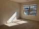 Spacious bedroom with large window and neutral carpeting at 7594 Shady Maple Way, Lithonia, GA 30038