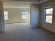 Spacious bedroom with neutral carpeting and multiple windows at 7594 Shady Maple Way, Lithonia, GA 30038