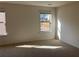 Bright bedroom with neutral walls and carpet, backyard view at 7594 Shady Maple Way, Lithonia, GA 30038
