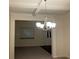 Bright dining room with coffered ceiling and chandelier, view to entry at 7594 Shady Maple Way, Lithonia, GA 30038