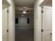 Bright hallway with ceiling fan and access to multiple rooms at 7594 Shady Maple Way, Lithonia, GA 30038