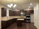 Modern kitchen with an island, dark cabinetry, and stainless steel appliances at 7594 Shady Maple Way, Lithonia, GA 30038