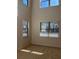 Bright living room with large windows and neutral carpeting at 7594 Shady Maple Way, Lithonia, GA 30038