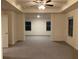 Spacious main bedroom with carpet, ceiling fan and two windows at 7594 Shady Maple Way, Lithonia, GA 30038