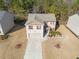 Two-story house with gray roof, a two-car garage, and landscaping at 1752 Alford Dr, Jonesboro, GA 30236