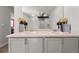 Double vanity bathroom with modern gray cabinets and a large mirror at 1752 Alford Dr, Jonesboro, GA 30236