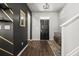 Modern foyer with dark-painted accent wall, hardwood floors, and seating at 1752 Alford Dr, Jonesboro, GA 30236