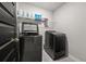 Modern laundry room with washer, dryer, and shelving at 1752 Alford Dr, Jonesboro, GA 30236