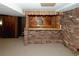 Finished basement bar with brick walls and wood accents at 2963 Thompson Cir, Decatur, GA 30034