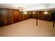 Spacious finished basement with wood paneling and neutral carpeting at 2963 Thompson Cir, Decatur, GA 30034
