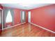 Bedroom with hardwood floors and coral walls at 2963 Thompson Cir, Decatur, GA 30034