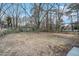 Large backyard with mature trees and mostly brown grass at 3355 Renault Se Rd, Atlanta, GA 30354