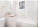 Clean bathroom, featuring a bathtub, granite countertop, and marble-like tile at 3355 Renault Se Rd, Atlanta, GA 30354