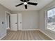 Bedroom with wood-look floors, ceiling fan, and ample closet space at 3688 Elinburg Cove Trl, Buford, GA 30519