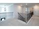 Hallway with decorative metal railing and view of staircase at 4783 Sultana Sw Way, Atlanta, GA 30331