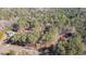 Overhead view of wooded acreage, asphalt road frontage, and multiple homesites surrounded by mature trees at 675 Mayes Rd, Powder Springs, GA 30127