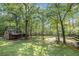 Enjoy a private backyard with a barn featuring mature trees and ample space for recreation at 675 Mayes Rd, Powder Springs, GA 30127