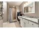 Well-lit bathroom with granite countertops, an enclosed shower, and a vanity with white cabinets at 675 Mayes Rd, Powder Springs, GA 30127