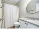 Clean bathroom featuring light-colored walls, a granite countertop, and a shower with a striped curtain at 675 Mayes Rd, Powder Springs, GA 30127