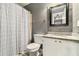 Cozy bathroom featuring gray walls, a granite countertop, and a shower with a patterned curtain at 675 Mayes Rd, Powder Springs, GA 30127