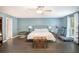 Bright and airy bedroom with a ceiling fan, neutral-colored walls, and wood floors at 675 Mayes Rd, Powder Springs, GA 30127