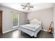 Tranquil bedroom with hardwood floors, a queen-sized bed, and ample natural light at 675 Mayes Rd, Powder Springs, GA 30127