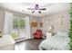 Sunlit bedroom with hardwood floors, a window, and a red leather chair at 675 Mayes Rd, Powder Springs, GA 30127