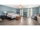 Spacious bedroom with hardwood floors, neutral-colored walls, and ample natural light from the windows at 675 Mayes Rd, Powder Springs, GA 30127