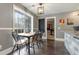 Cozy dining area with hardwood floors, a large window, and neutral wall paint at 675 Mayes Rd, Powder Springs, GA 30127