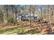 A view of the rear exterior of the house showing a deck and additional building at 675 Mayes Rd, Powder Springs, GA 30127