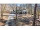 Charming single-story home with a long driveway and well-manicured lawn surrounded by mature trees at 675 Mayes Rd, Powder Springs, GA 30127