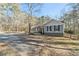 Gray house with stone accents and a long driveway at 675 Mayes Rd, Powder Springs, GA 30127