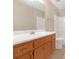 Bathroom with wood vanity, single sink, and shower/tub combo at 1308 Crumbley Rd, Mcdonough, GA 30252