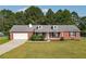 Brick ranch house with attached garage and spacious yard at 1308 Crumbley Rd, Mcdonough, GA 30252