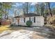 Brick ranch house with driveway and mature trees at 1903 Wildwood Dr, Decatur, GA 30032