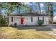 Charming brick ranch home with red door and landscaped lawn at 1903 Wildwood Dr, Decatur, GA 30032
