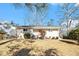 Newly renovated Ranch home with a red door and landscaped lawn at 2352 Scotty Cir, Decatur, GA 30032