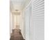 Bright hallway with wood flooring and white louvered closet doors at 2352 Scotty Cir, Decatur, GA 30032