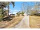 Front view of a charming house with a long driveway and mature trees at 2352 Scotty Cir, Decatur, GA 30032