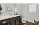 Modern bathroom with dark vanity and white toilet at 505 Blue Mountain Rise, Canton, GA 30114
