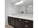 Bathroom with dark vanity, large mirror, and white countertop at 505 Blue Mountain Rise, Canton, GA 30114
