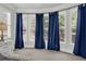 Bright bedroom featuring a bay window with blue curtains at 505 Blue Mountain Rise, Canton, GA 30114