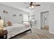 Bright bedroom with a queen bed, ceiling fan, and window coverings at 505 Blue Mountain Rise, Canton, GA 30114