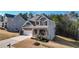 Two-story house with gray siding, brick accents, and a three-car garage at 505 Blue Mountain Rise, Canton, GA 30114
