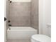 Bathroom with shower/tub combo and gray tile at 488 Broom Dr, Cumming, GA 30040