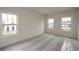 Well-lit bedroom featuring three windows and new carpet at 488 Broom Dr, Cumming, GA 30040