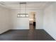 Dining room features dark hardwood floors and a modern light fixture at 488 Broom Dr, Cumming, GA 30040